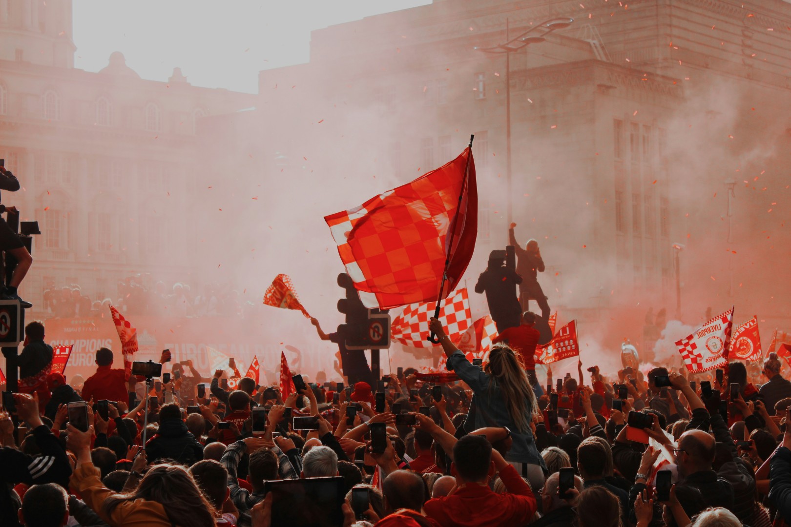 A large crowd of people holding flags