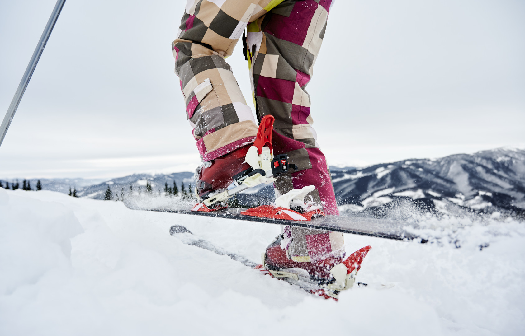 closeup cropped snapshot skier s legs ski fastening skis making step forward