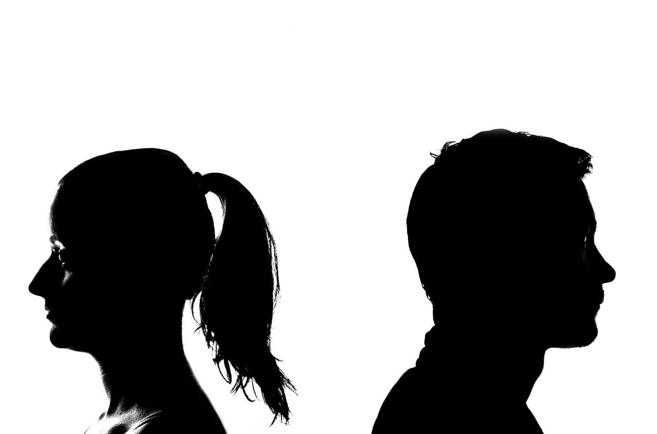 Male and female heads turning away from each other