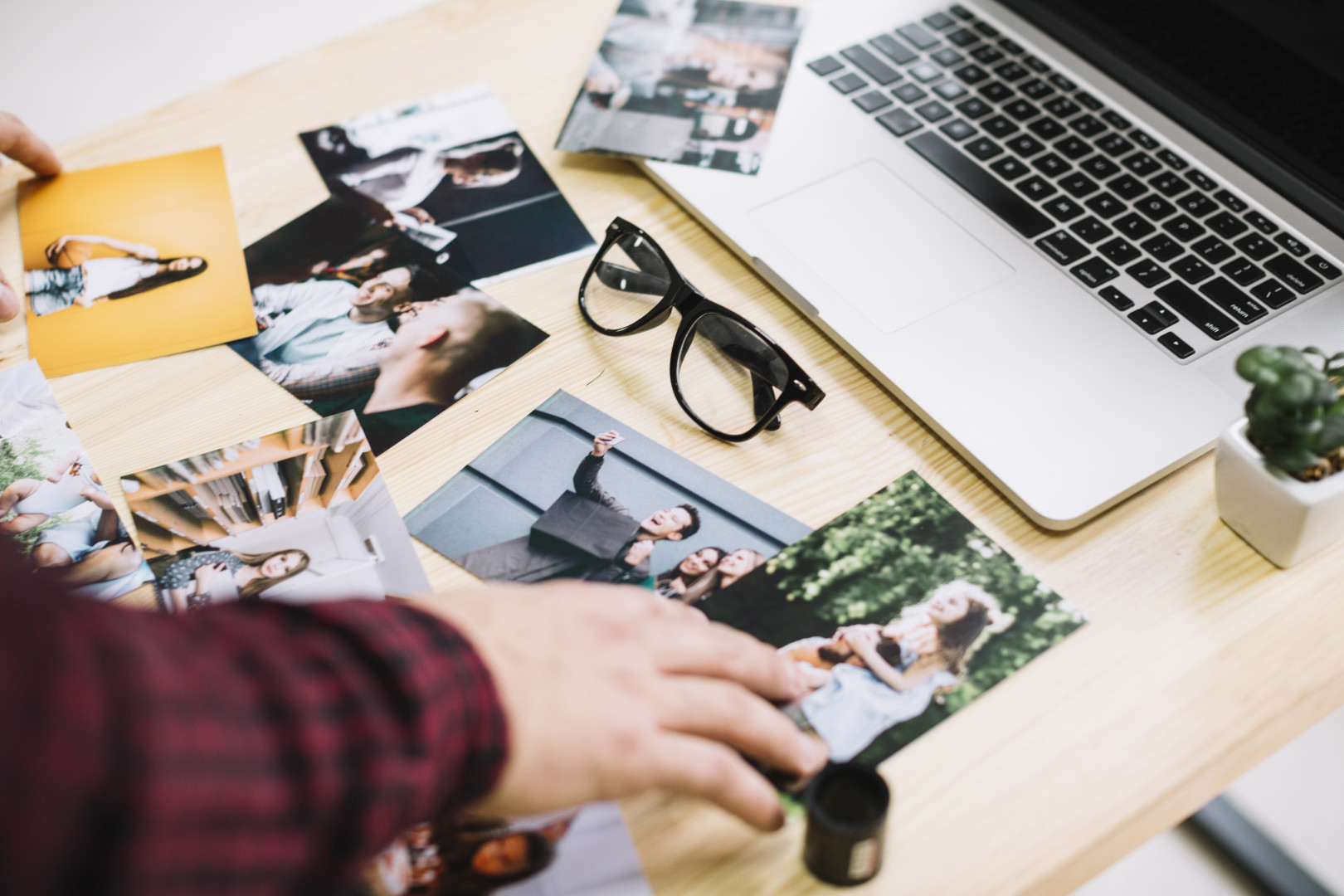 laptop surrounded by pictures