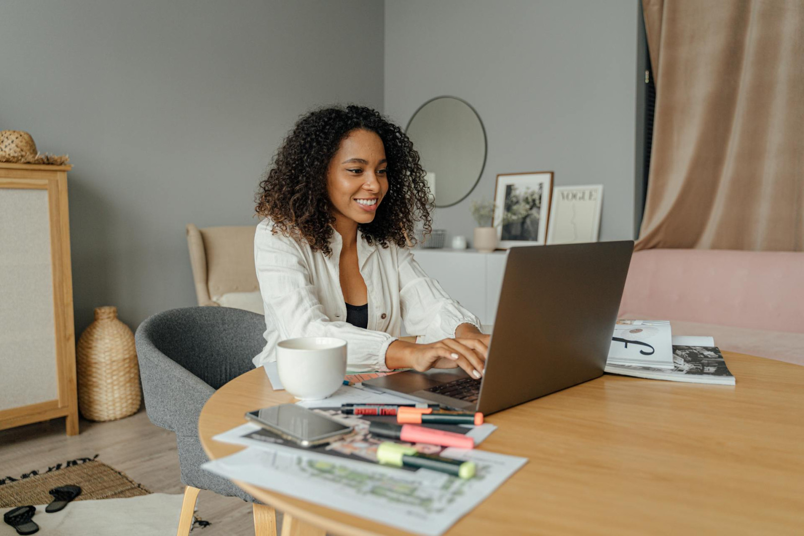 A Woman in White Long Sleeves using a Laptop