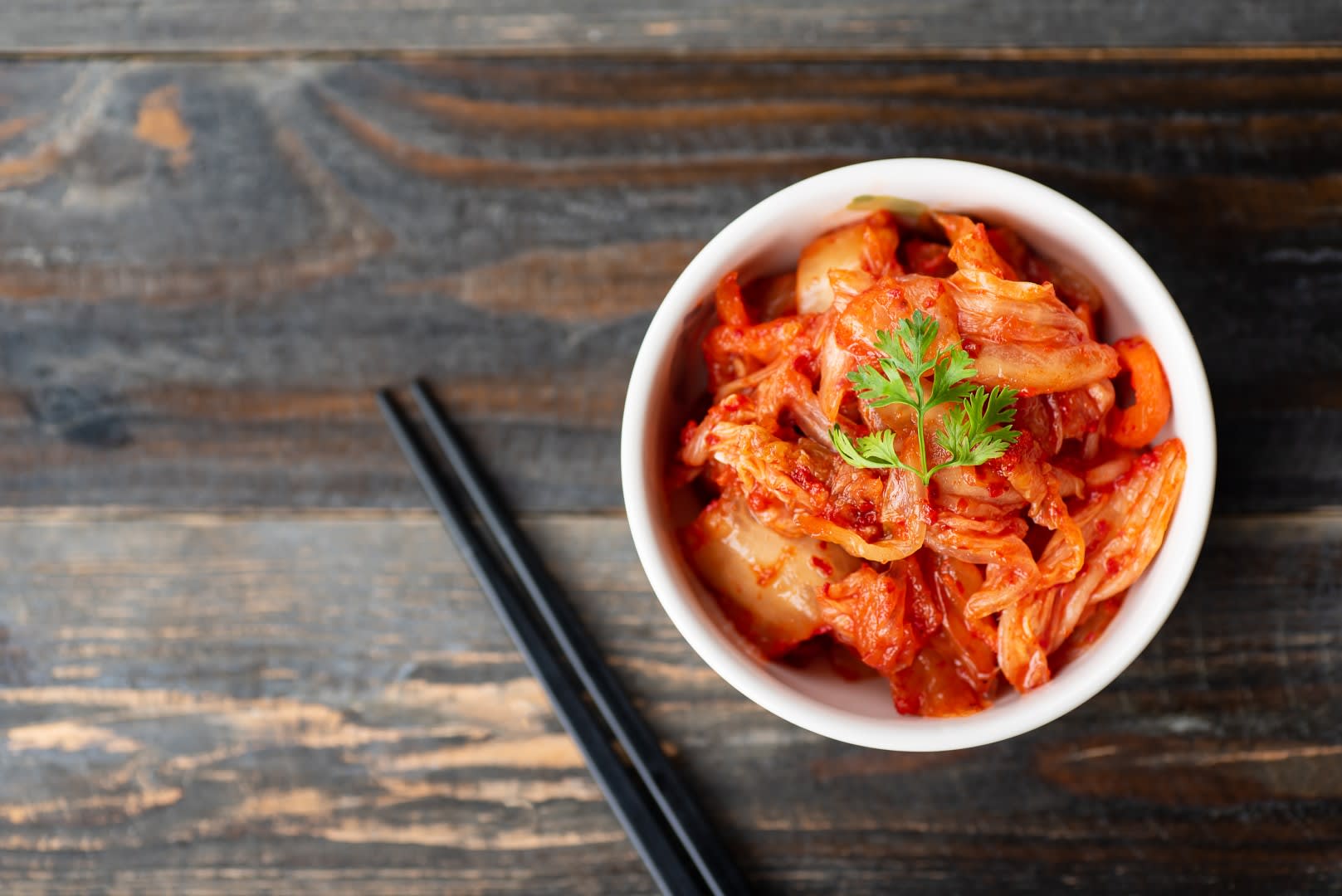 Kimchi and Chopsticks on Wooden Table