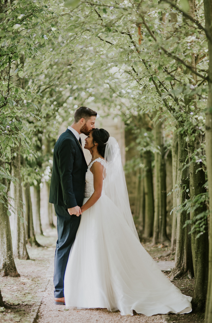 Tythe Barn Groom Gives Bride Forehead Kiss